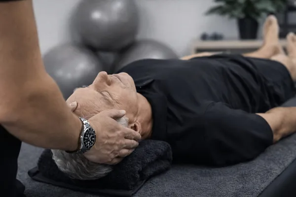 Physiotherapist treating headaches and migraines