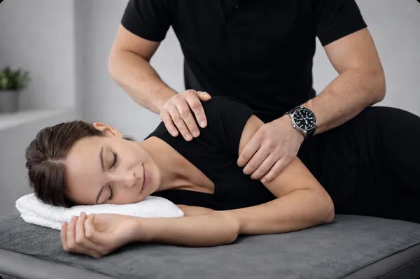 Physiotherapist treating shoulder and upper limb pains